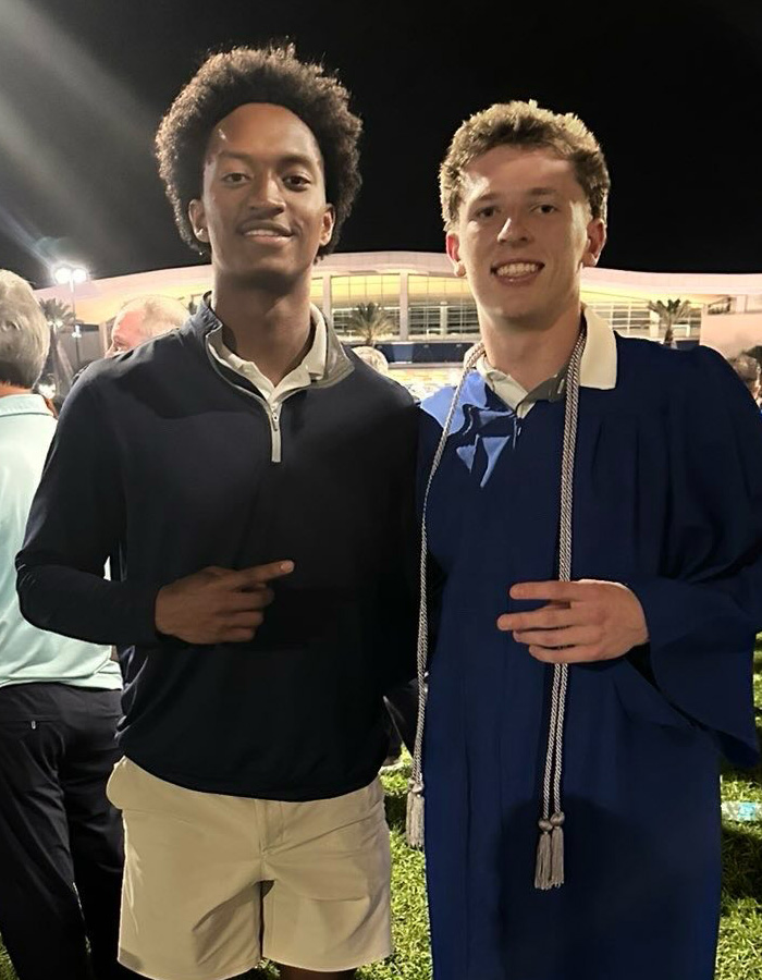 Nolan Wells, on the left, smiling next to a friend in a graduation gown, raising questions about his case.