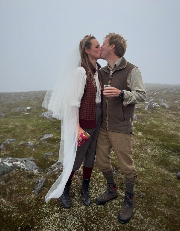 Woman in a wedding veil and man in outdoor gear kissing on a misty landscape, celebrating her fairytale wedding after being Prince William's decoy girlfriend. Woman in a wedding veil and man in outdoor gear kissing on a misty landscape, celebrating her fairytale wedding after being Prince William's decoy girlfriend.