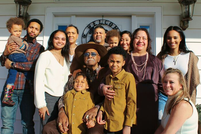 A large family with international partners poses for a group photo, sharing their culture shocks and experiences.