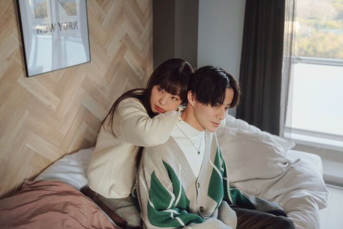 A woman comforts a man, possibly ignoring red flags in their relationship.