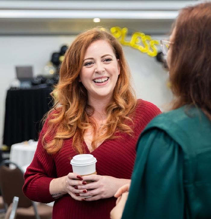 Adult content creator in a red dress, holding coffee, laughing and chatting, revealing frustrating attitude of married men. Adult content creator in a red dress, holding coffee, laughing and chatting, revealing frustrating attitude of married men.