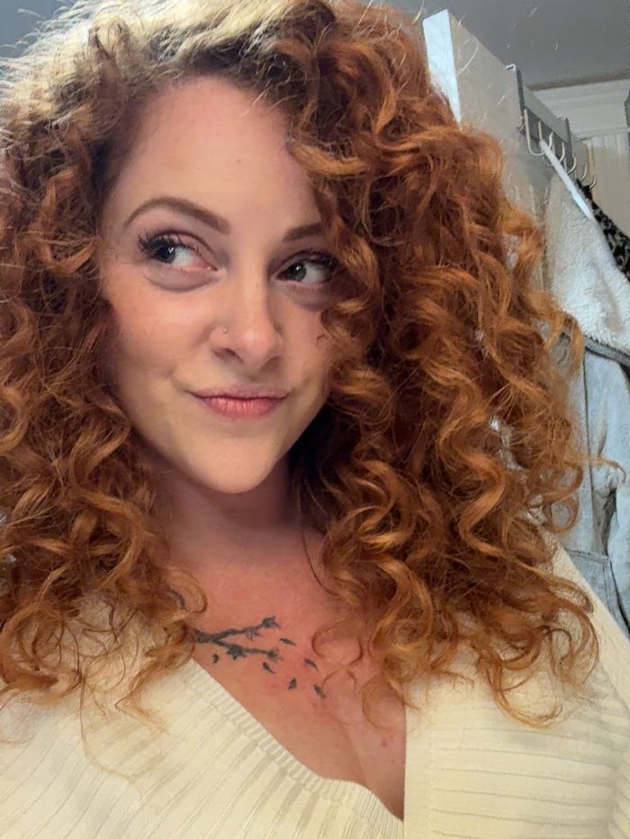 An adult content creator with curly hair looks sideways, contemplating the frustrating attitude of married men. An adult content creator with curly hair looks sideways, contemplating the frustrating attitude of married men.