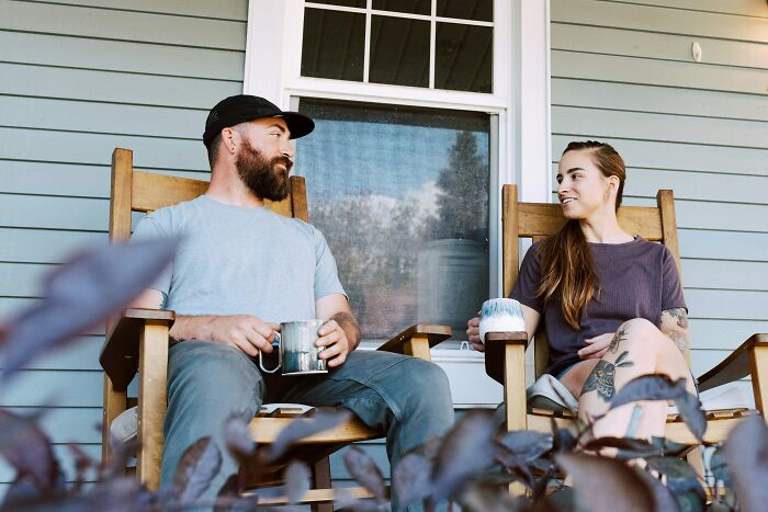 A couple sitting on a porch, talking and observing psychological red flags.