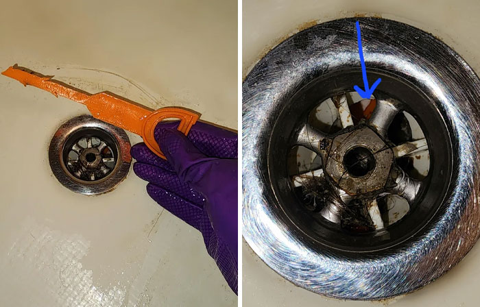 A hand fixing a clogged drain in a bathtub using an orange tool to extract hair and debris, addressing common plumbing problems.