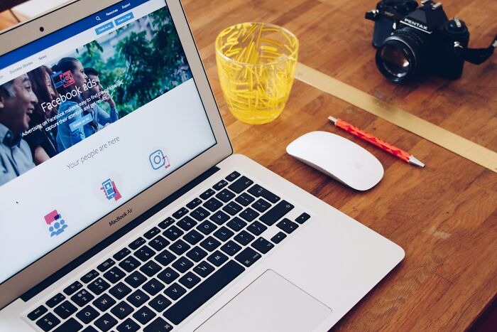 A laptop displaying Facebook ads, highlighting how people are getting scammed online without knowing it.
