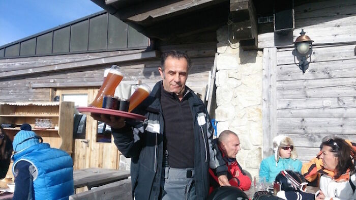 A waiter carrying drinks on a tray outdoors, moments before disaster struck.