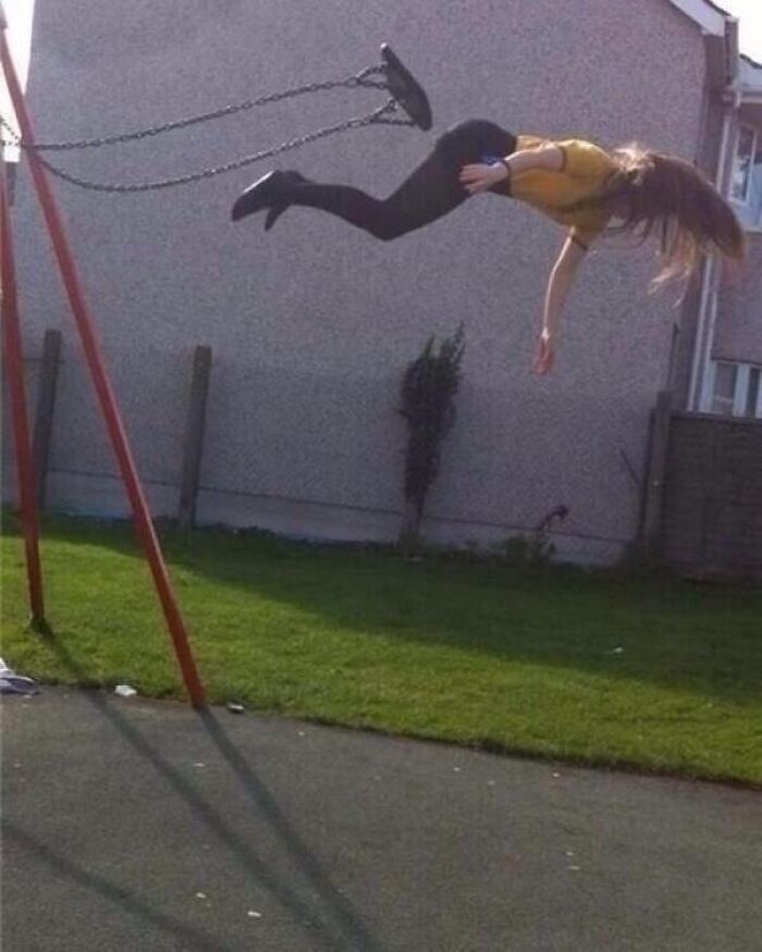 A young woman flies through the air on a swing, captured in a hilarious photo moments before disaster struck.