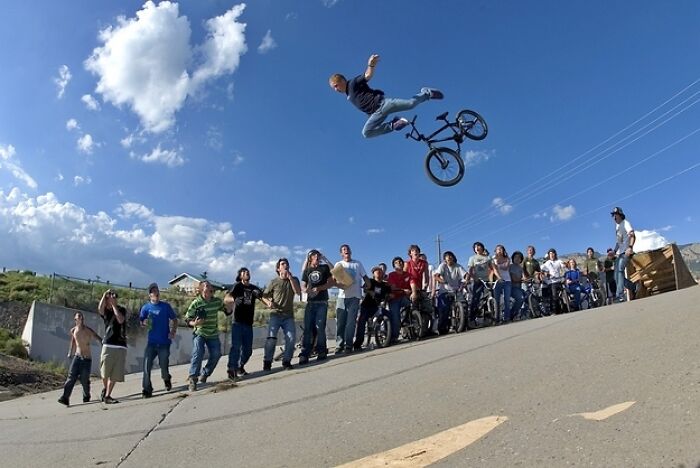 A BMX rider performs a high jump with his bike, captured moments before disaster.