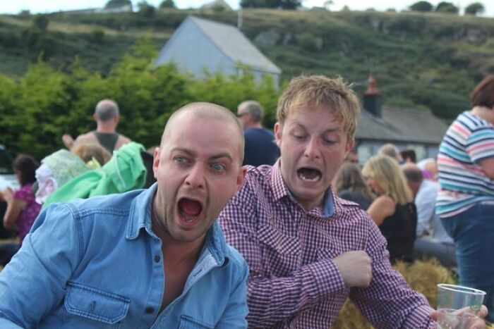 Two men with wide open mouths, seemingly screaming, captured in a hilarious photo moments before disaster.