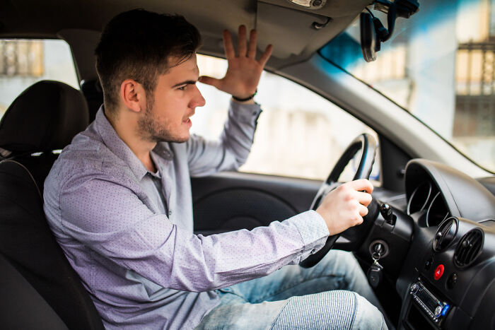 An angry man yelling while driving, representing psycho moments from partners.