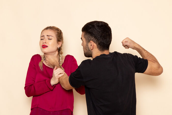 A man chokes a woman, depicting psycho moments from partners.