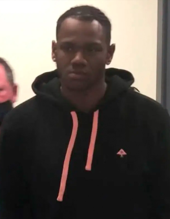 Mugshot of a young man in a black hoodie, looking serious after a sibling dispute escalated.