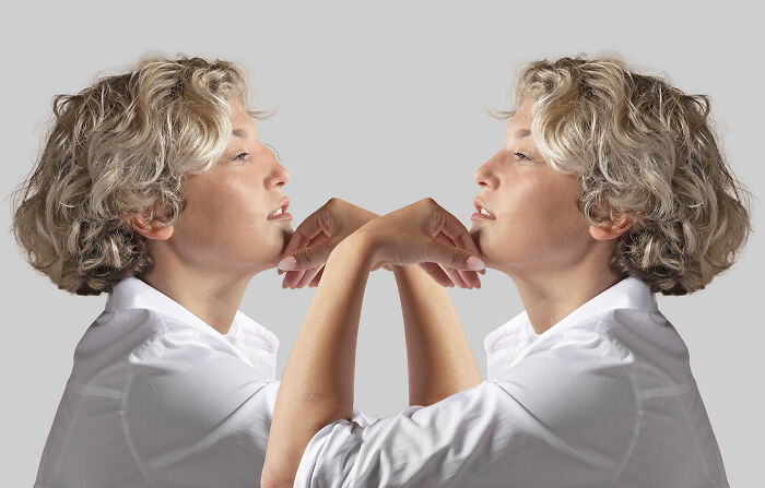 A woman reflected, showcasing interesting facts about human perception and the brain.