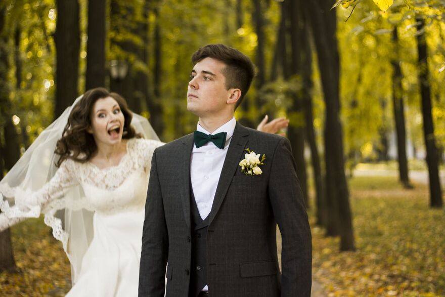 A bride running after a groom in a funny wedding photo, capturing a playful, silly moment.