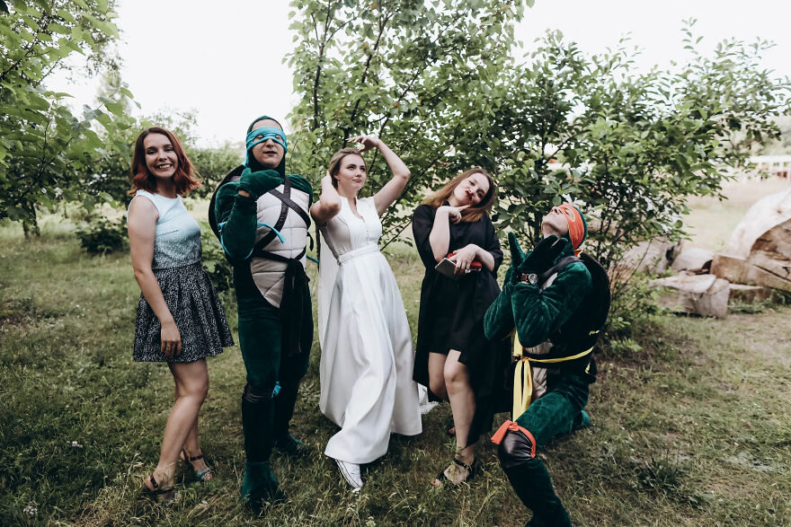 A bride and guests in funny wedding photos, some dressed as Ninja Turtles.