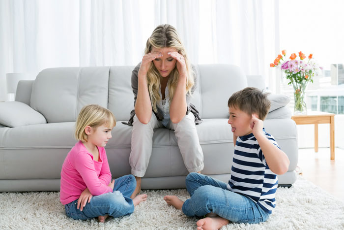 Frustrated woman with children highlighting the teen and sister's 3rd pregnancy plan Frustrated woman with children highlighting the teen and sister's 3rd pregnancy plan