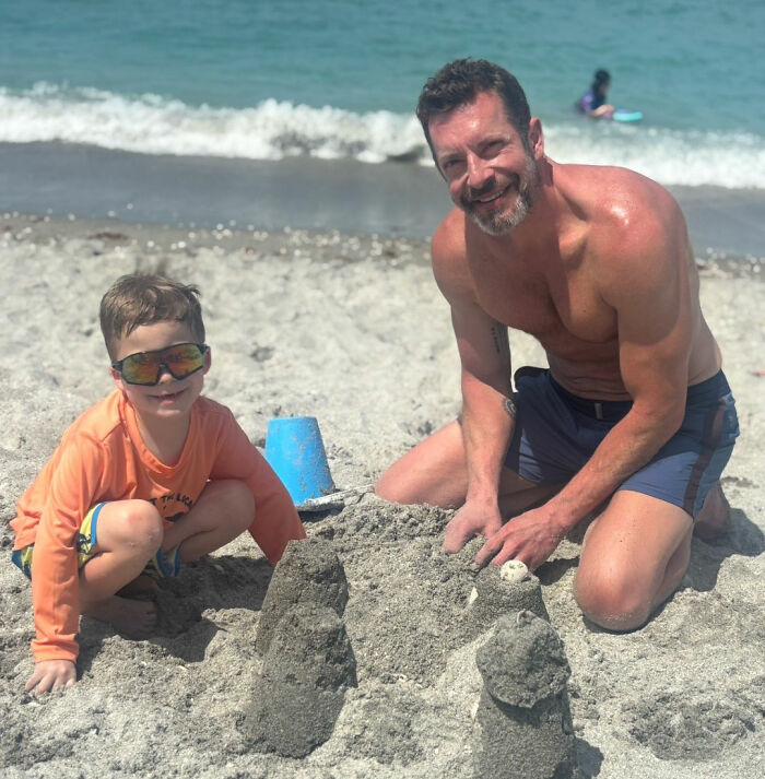 A Michigan man and a child building a sandcastle, in the context of Reddit posts and a family tragedy.