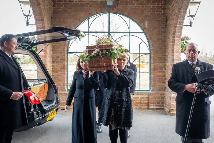 Mourners carrying a casket, illustrating a solemn, potentially socially awkward cringe moment.