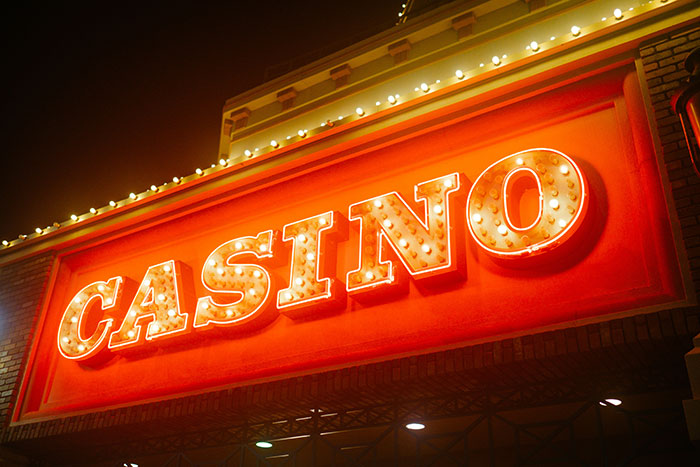 A bright neon casino sign at night, symbolizing the risks and potential instant karma in divorce.