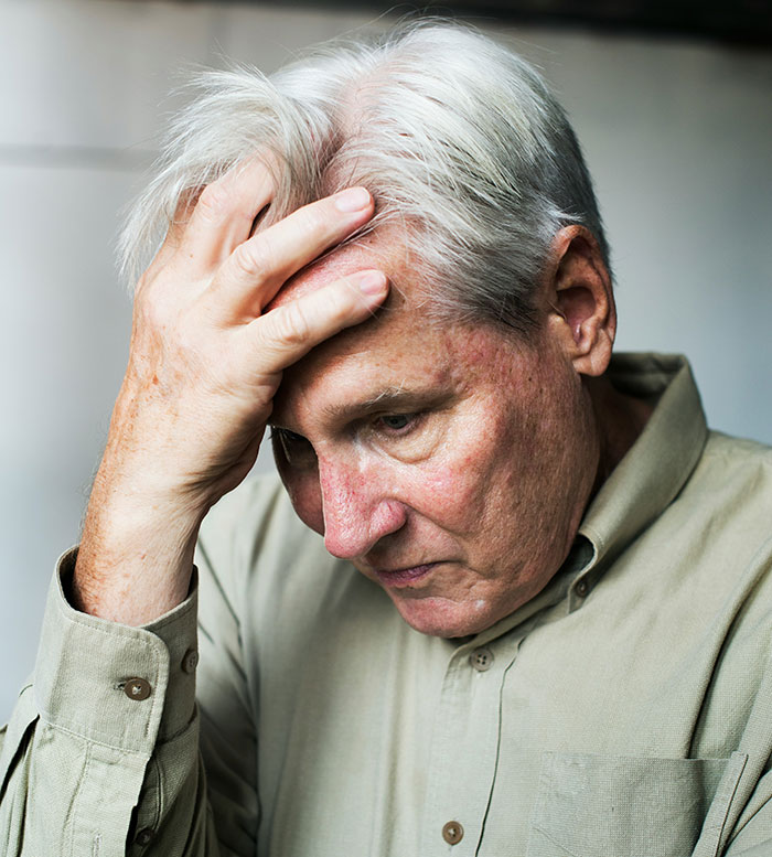 An elderly man looking distressed, reflecting on instant karma and divorce lawyers.