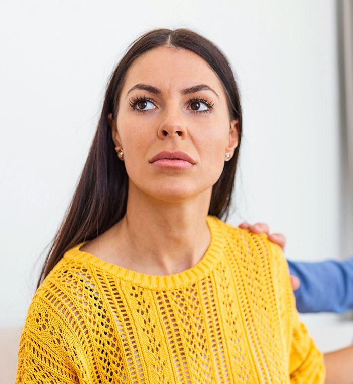 A woman looking worried, perhaps reflecting on instant karma during a challenging divorce case.