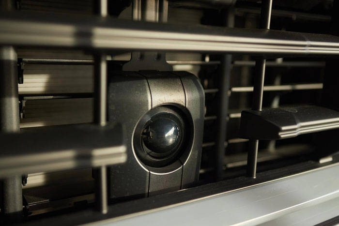 Close-up of a spy camera lens integrated into the front grill of a vehicle, part of the spy camera room search. Close-up of a spy camera lens integrated into the front grill of a vehicle, part of the spy camera room search.