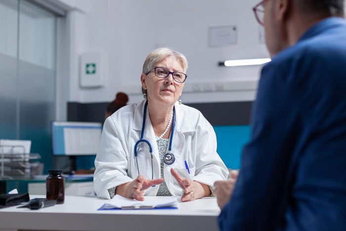 Doctor consults with a patient about nervous system health and when to give up beer at a certain age.
