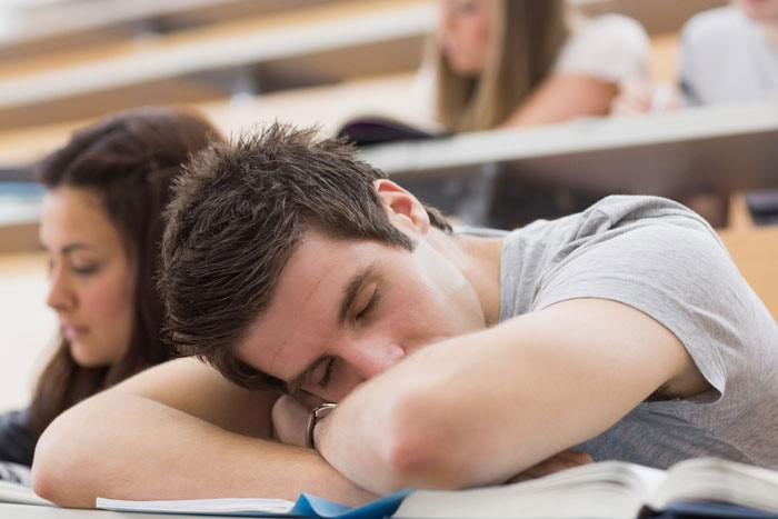 A student sleeping in a lecture, possibly due to poor performance or refusing group work leading to a hard fail. A student sleeping in a lecture, possibly due to poor performance or refusing group work leading to a hard fail.