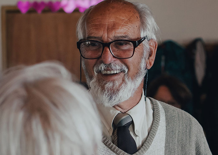 Elderly man smiling, a fact about the human body.