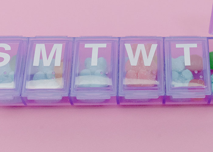 A pill organizer filled with colorful gummy candies, illustrating intriguing human body facts for medical students.