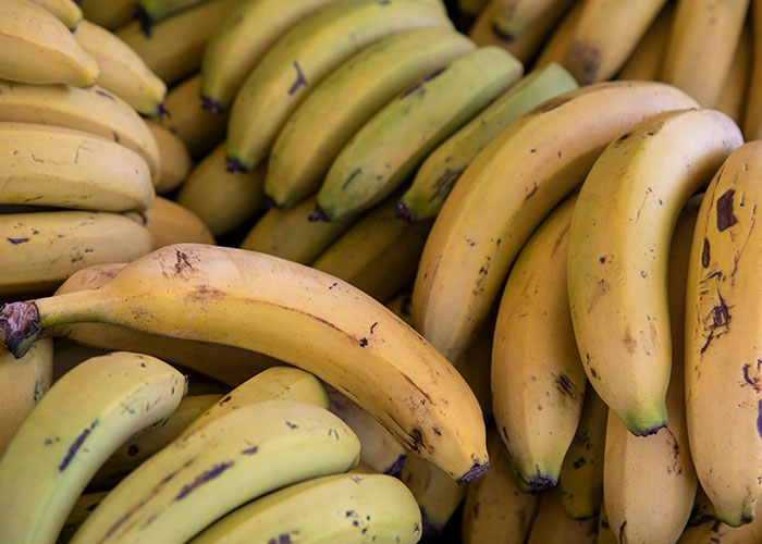 A pile of fresh bananas, a common food with surprising facts about the human body.