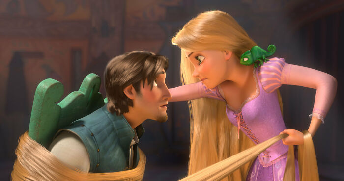 Animated Disney Princess Rapunzel with long blonde hair, a green chameleon on her shoulder, and Flynn Rider tied with her hair, sparking debate over the new remake. Animated Disney Princess Rapunzel with long blonde hair, a green chameleon on her shoulder, and Flynn Rider tied with her hair, sparking debate over the new remake.