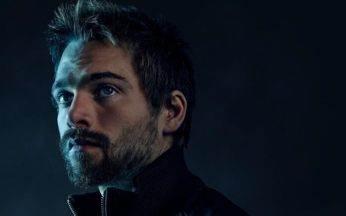 A Hollywood Star with a beard looks intensely, featuring blue eyes against a dark background, revealing his Scientology purification ritual. A Hollywood Star with a beard looks intensely, featuring blue eyes against a dark background, revealing his Scientology purification ritual.