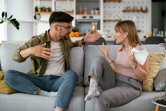 Couple arguing on couch illustrating love life conflicts and challenges