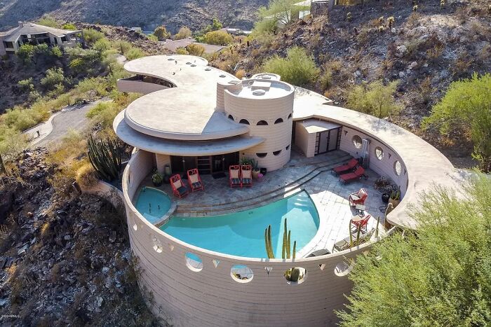 Remarkable historic interiors: a unique round house with a central pool, showcasing iconic furniture designs.