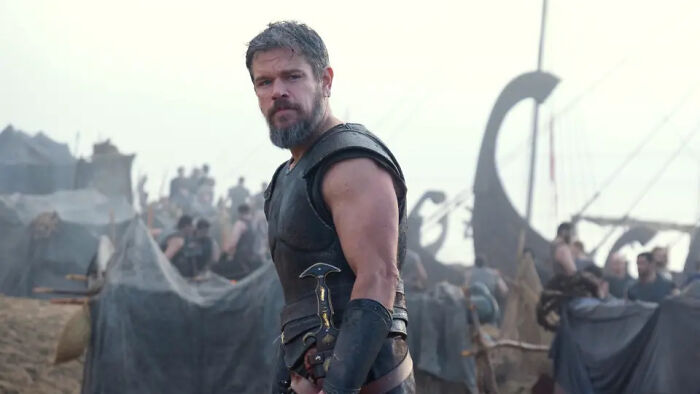 A bearded man in ancient armor looks sternly at the viewer, for The Odyssey trailer. A bearded man in ancient armor looks sternly at the viewer, for The Odyssey trailer.