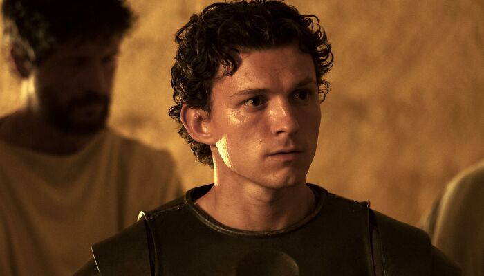 A close-up of a young man with curly hair and serious expression. Christopher Nolan's bizarre rules for items banned from set. A close-up of a young man with curly hair and serious expression. Christopher Nolan's bizarre rules for items banned from set.
