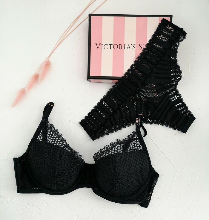 A black lace bra and matching underwear set, with a Victoria's Secret box, representing products and items.