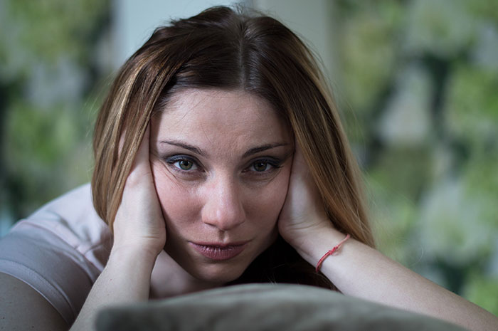 A woman looking tired, contemplating the Stepmom K-Pop character incident at the kid's birthday. A woman looking tired, contemplating the Stepmom K-Pop character incident at the kid's birthday.