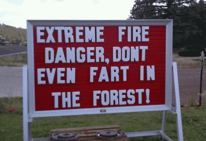 A humorous red sign in the USA warning of extreme fire danger: Don't Even Fart in the Forest! Photos of the USA.