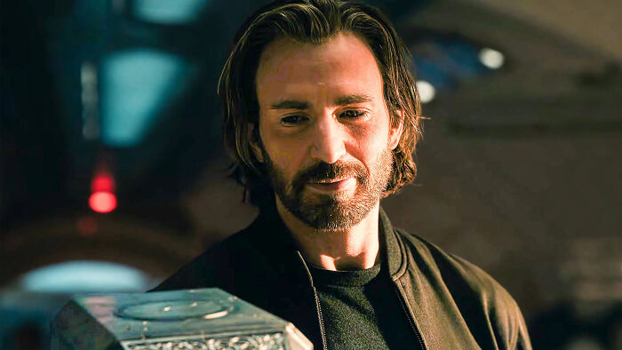 Chris Evans with a beard and long hair, smiling next to Mjolnir, a part of his internet glowdown. Chris Evans with a beard and long hair, smiling next to Mjolnir, a part of his internet glowdown.