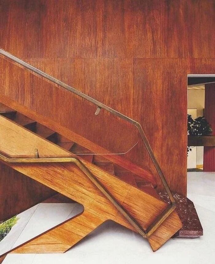 Remarkable historic interiors with unique wooden stairs and paneled walls, showcasing iconic furniture designs.