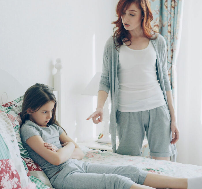 Mother pointing finger at her sad daughter, an emotional scene that may lead to hair shaving punishment. Mother pointing finger at her sad daughter, an emotional scene that may lead to hair shaving punishment.