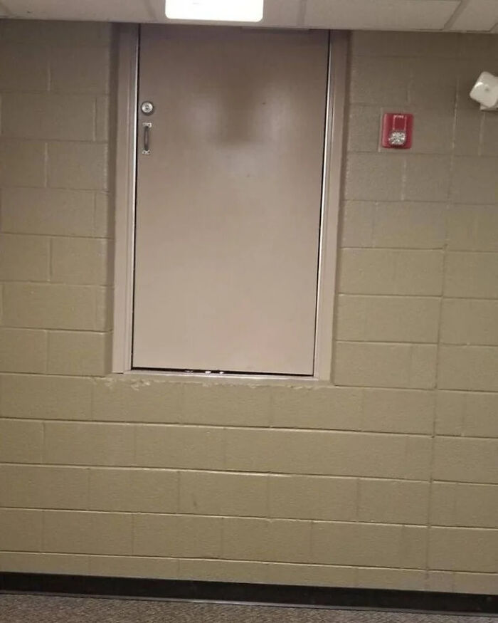 A construction fail shows a door installed halfway up a wall, making it inaccessible, a clear example of poor construction.