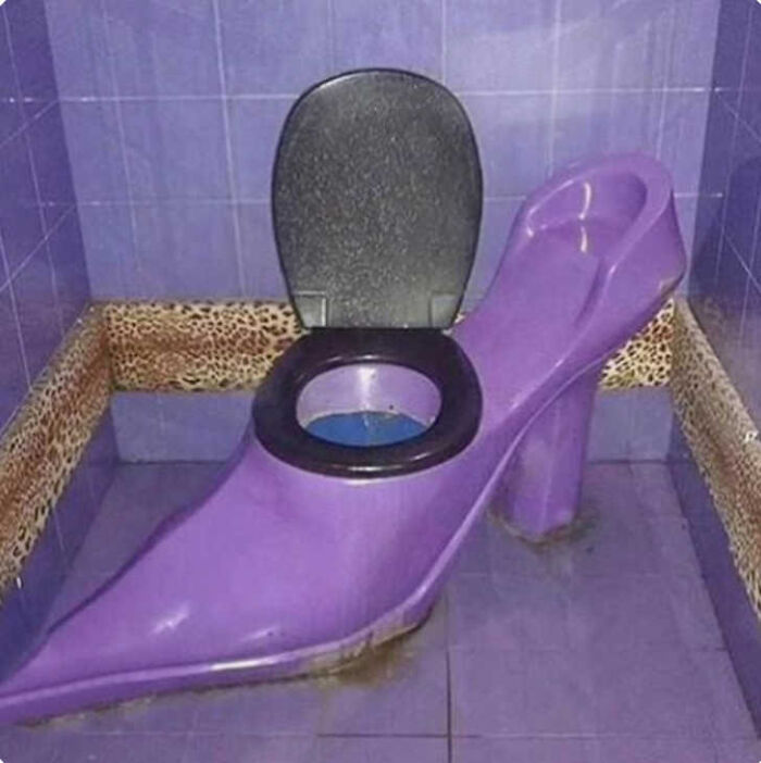 A toilet shaped like a purple high-heeled shoe, a clear instance of construction fails.