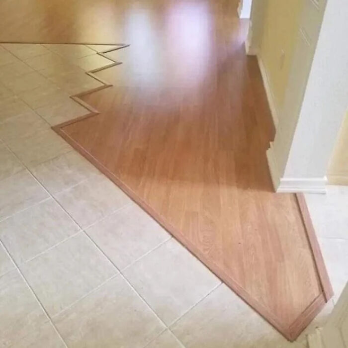 A zigzag pattern where two types of flooring meet, an example of construction fails.