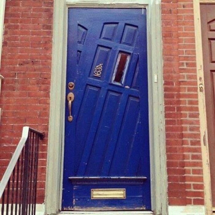 A crooked blue front door with the number 163A, an example of peculiar construction fails.