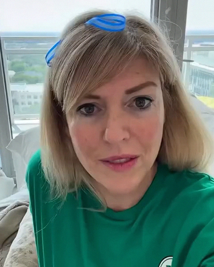 A white Karen woman with blonde hair and blue hair accessories looks directly at the camera, being an internet villain. A white Karen woman with blonde hair and blue hair accessories looks directly at the camera, being an internet villain.