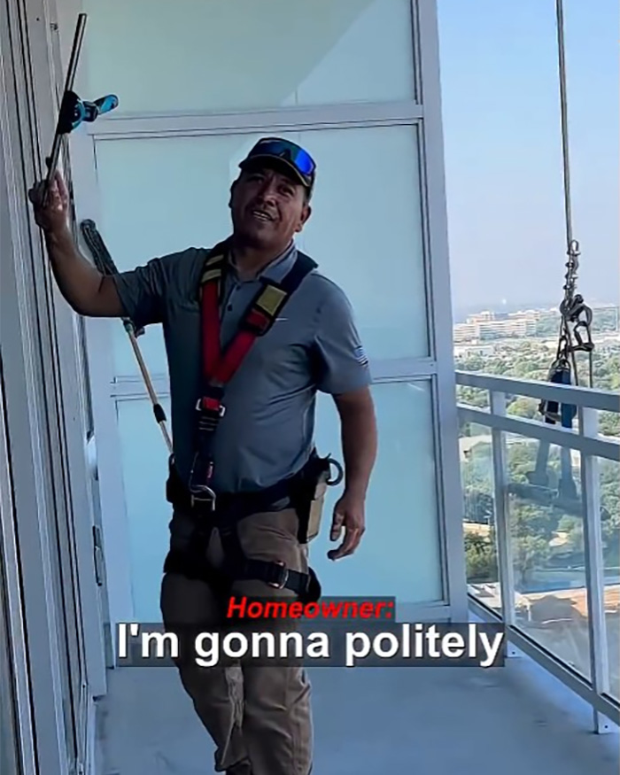 A Hispanic window washer in safety gear on a high-rise balcony, looking at the camera and smiling, about to do his job. A Hispanic window washer in safety gear on a high-rise balcony, looking at the camera and smiling, about to do his job.