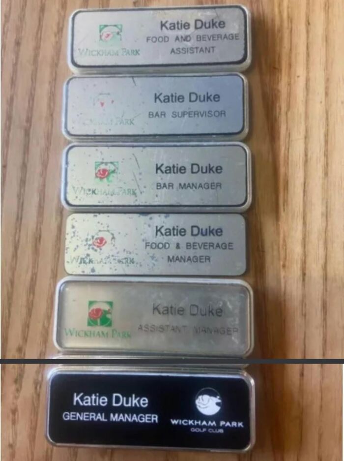 A collection of name tags showing Katie Duke's career progression to General Manager, illustrating wholesome achievements.